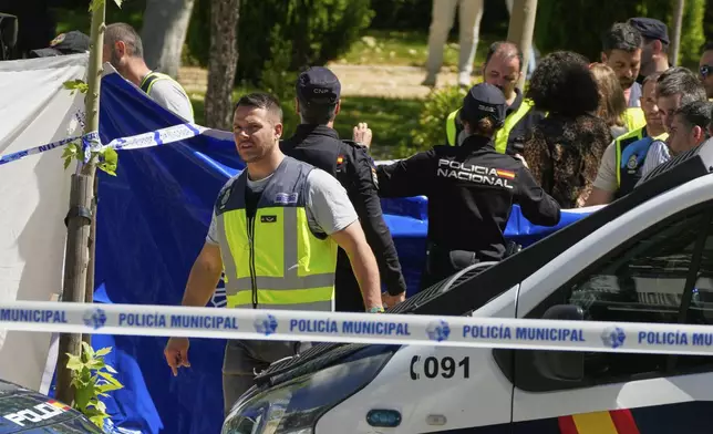 Members of the judicial police at the scene after an adviser to former Ukrainian president Viktor Yanukovych was shot, outside a school in Madrid, Spain, Wednesday, May 21, 2025. (AP Photo/Paul White)