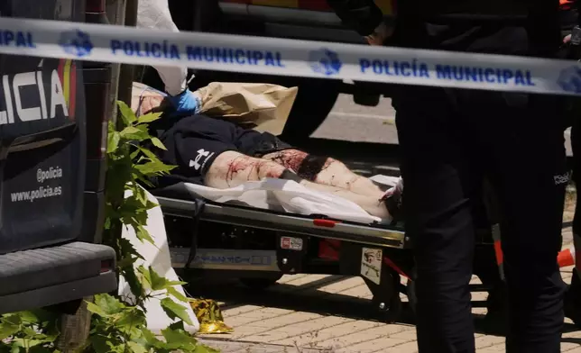 A view of the scene after Andriy Portnov, an adviser to former Ukrainian president Viktor Yanukovych, was shot, outside a school in Madrid, Spain, Wednesday, May 21, 2025. (AP Photo/Paul White)