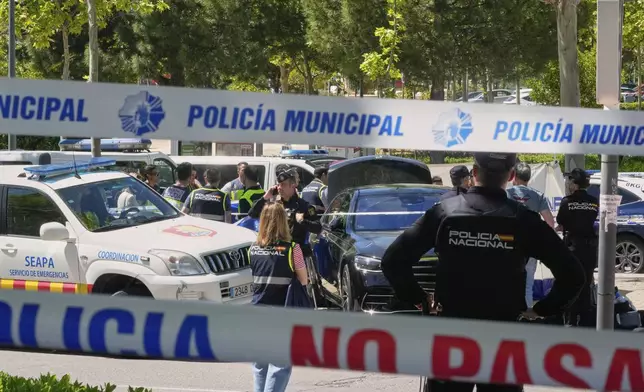 Police officers cordon off the area after an adviser to former Ukrainian president Viktor Yanukovych was shot, outside a school in Madrid, Spain, Wednesday, May 21, 2025. (AP Photo/Paul White)