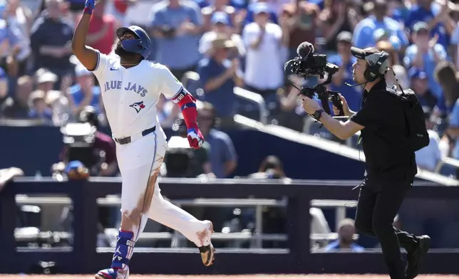 Toronto Blue Jays' Vladimir Guerrero Jr. reacts after hitting a solo home run against the Tampa Bay Rays during the third inning of a baseball game in Toronto, Thursday, May 15, 2025. (Nathan Denette/The Canadian Press via AP)