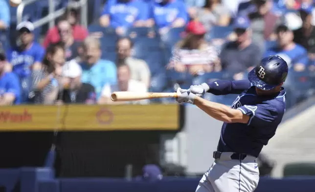 Tampa Bay Rays' Brandon Lowe (8) hits a two-run home run against the Toronto Blue Jays during the first inning of a baseball game in Toronto, Thursday, May 15, 2025. (Nathan Denette/The Canadian Press via AP)
