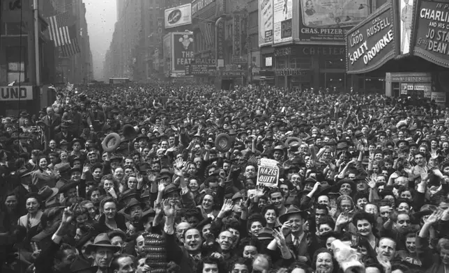 FILE - This general view of Times Square, New York at 11 a.m. on May 7, 1945, shows New Yorkers jamming the streets to cheer the news of the unconditional surrender of Germany. (AP Photo/Harry Harris, File)