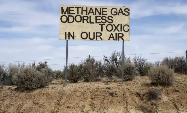 A sign protesting emissions from oil and gas stands across from Lybrook Elementary School, in Counselor, N.M., Navajo Nation, on Tuesday, March 11, 2025. (Nadav Soroker/Searchlight New Mexico via AP)