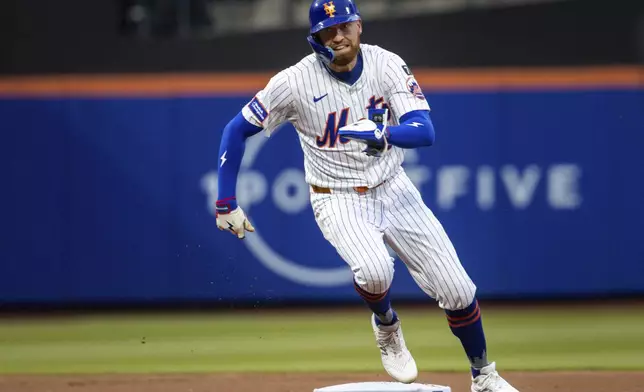New York Mets' Brandon Nimmo (9) runs back to first base after Juan Soto's hit was caught during the first inning against the Chicago White Sox, Tuesday, May 27, 2025, in New York. (AP Photo/Angelina Katsanis)