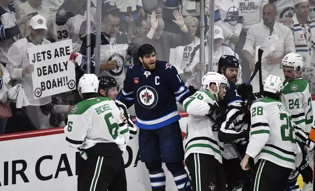 Winnipeg Jets' Adam Lowry (17) and Dallas Stars players push and shove at the end of a play during third period NHL playoff hockey action in Winnipeg, Thursday, May 15, 2025. (Fred Greenslade/The Canadian Press via AP)