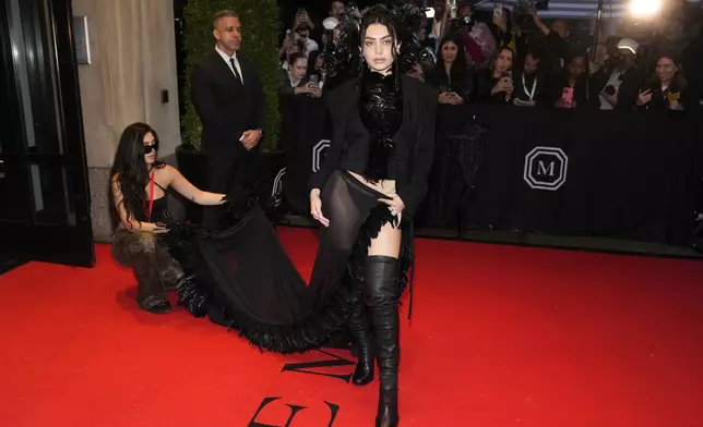 Charli xcx departs The Mark Hotel prior to attending The Metropolitan Museum of Art's Costume Institute benefit gala celebrating the opening of "Superfine: Tailoring Black Style" on Monday, May 5, 2025, in New York. (Photo by Charles Sykes/Invision/AP)