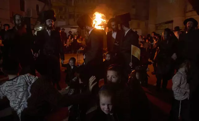 Ultra-Orthodox Jews dance around a bonfire during Lag BaOmer celebrations in Jerusalem, Thursday, May 15, 2025. (AP Photo/Ohad Zwigenberg)