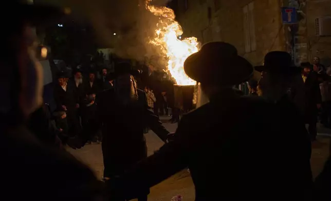 Ultra-Orthodox Jews dance around a bonfire during Lag BaOmer celebrations in Jerusalem, Thursday, May 15, 2025. (AP Photo/Ohad Zwigenberg)