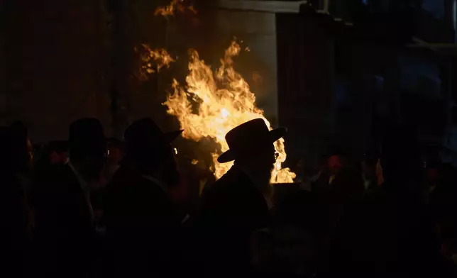 An ultra-Orthodox Jewish man dances around a bonfire during Lag BaOmer celebrations in Jerusalem, Thursday, May 15, 2025. (AP Photo/Ohad Zwigenberg)