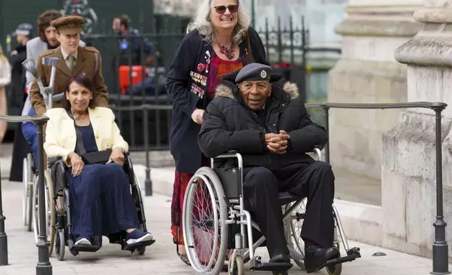 Veteran Gilbert Clarke, right, arrives to attend a Service of Thanksgiving at Westminster Abbey on V-E Day in London, Thursday, May 8, 2025.(AP Photo/Kirsty Wigglesworth)