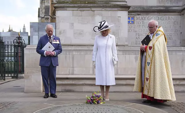 Britain's King Charles III and Queen Camilla lay flowers at the Innocent Victims' Memorial, following a Service of Thanksgiving at Westminster Abbey on V-E Day in London, Thursday, May 8, 2025. (Aaron Chown/Pool Photo via AP)