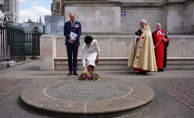 Britain's Prince William and Dean of Westminster, the Very Reverend Dr David Hoyle, right, look on as Kate, Princess of Wales lays flowers at the Innocent Victims' Memorial, following a Service of Thanksgiving at Westminster Abbey on V-E Day in London, Thursday, May 8, 2025. (Aaron Chown/Pool Photo via AP)