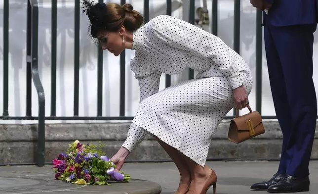 Britain's Kate, Princess of Wales, puts down flowers after attending a Service of Thanksgiving at Westminster Abbey on V-E Day in London, Thursday, May 8, 2025.(AP Photo/Kirsty Wigglesworth)