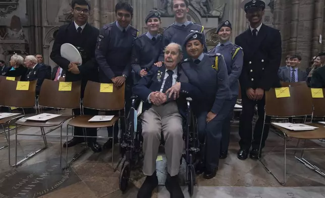 Veteran Harry Winter meets young service personnel before the Service of Thanksgiving at Westminster Abbey on V-E Day in London, Thursday, May 8, 2025. (Julian Simmonds/Pool Photo via AP)
