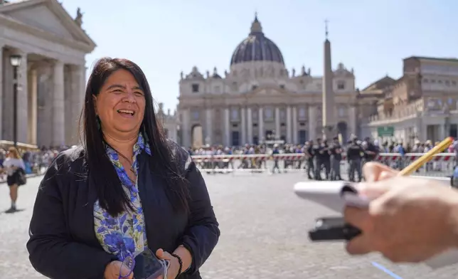 Peruvian investigative journalist Paola Margot Ugaz Cruz talks with the Associated Press near St. Peter's Square at the Vatican, Monday, May 19, 2025. (AP Photo/Gregorio Borgia)