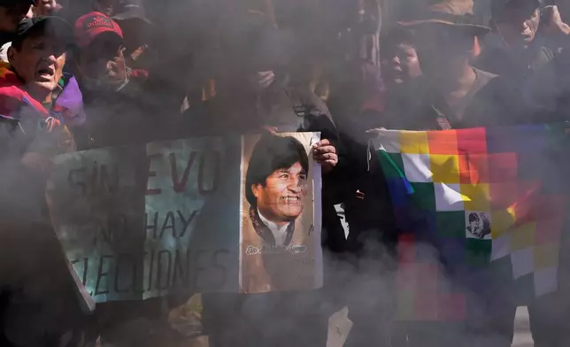 Supporters hold a sign with an image of former President Evo Morales and a message that reads in Spanish, "Without Evo, there are no elections," during a protest demanding he be allowed to compete in the upcoming presidential election, near the Supreme Electoral Tribunal in La Paz, Bolivia, Thursday, May 29, 2025. (AP Photo/Juan Karita)