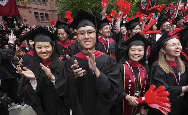 Graduates applaud during commencement ceremonies at Harvard University, Thursday, May 29, 2025, in Cambridge, Mass. (AP Photo/Charles Krupa)