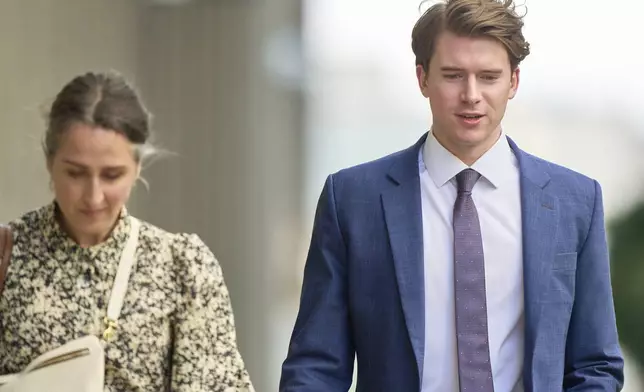 Carter Hart, right, one of five members of Canada’s 2018 world junior hockey team charged with sexual assault last year for an incident that allegedly took place in June 2018, leaves the London Courthouse in London, Ontario, Friday, May 2, 2025. (Geoff Robins/The Canadian Press via AP)