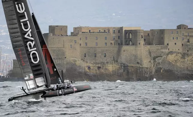 FILE -Oracle Racing Team of the U.S. sails past Castel dell'Ovo castle as it competes during the 34th America's Cup World Series Race day 1 regatta, in the Gulf of Naples, southern Italy, Wednesday, April 11, 2012. (AP Photo/Salvatore Laporta, File)