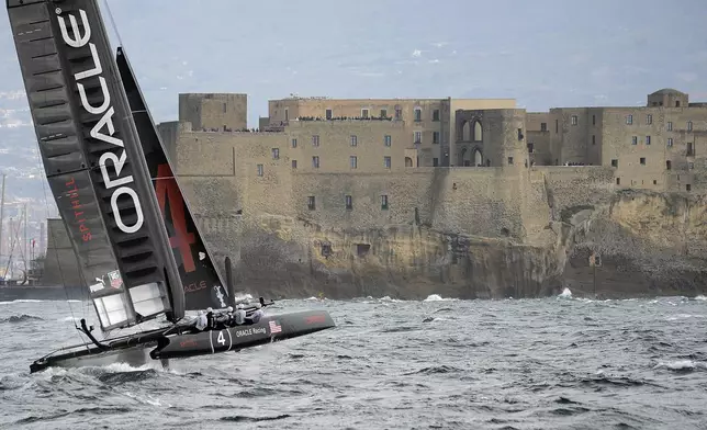 FILE - Oracle Racing Team of the U.S. sails past Castel dell'Ovo castle as it competes during the 34th America's Cup World Series Race day 1 regatta, in the Gulf of Naples, southern Italy, Wednesday, April 11, 2012. (AP Photo/Salvatore Laporta, File)