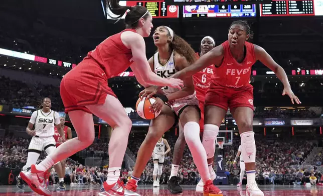 Indiana Fever guard Caitlin Clark, left, fouls Chicago Sky forward Angel Reese, center, during the second half an WNBA basketball game in Indianapolis, Saturday, May 17, 2025. (AP Photo/AJ Mast)