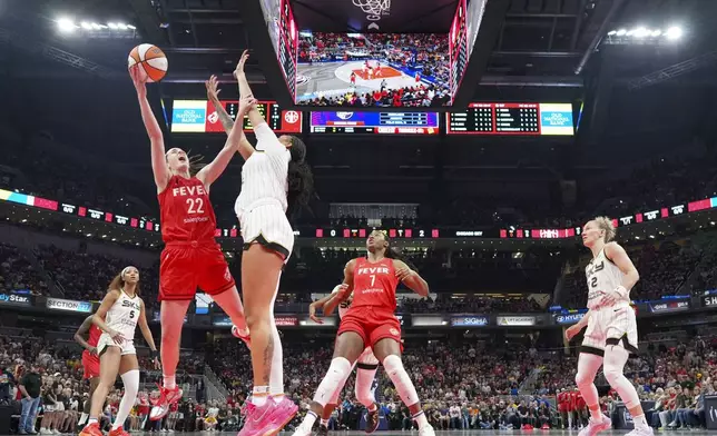 Indiana Fever guard Caitlin Clark (22) shoots around Chicago Sky center Kamilla Cardoso (10) during the first half of an WNBA basketball game in Indianapolis, Saturday, May 17, 2025. (AP Photo/AJ Mast)