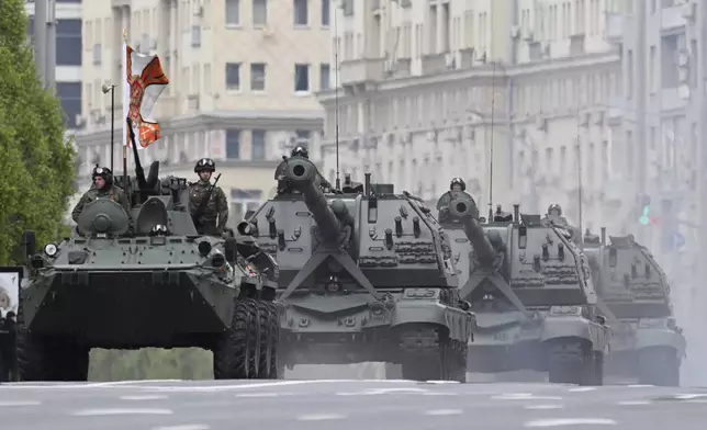 Russian armoured personnel carrier and Msta-S self-propelled howitzers roll along the Garden Ring after the Victory Day military parade general rehearsal in Moscow, Russia, Wednesday, May 7, 2025. (AP Photo/Dmitry Serebryakov)