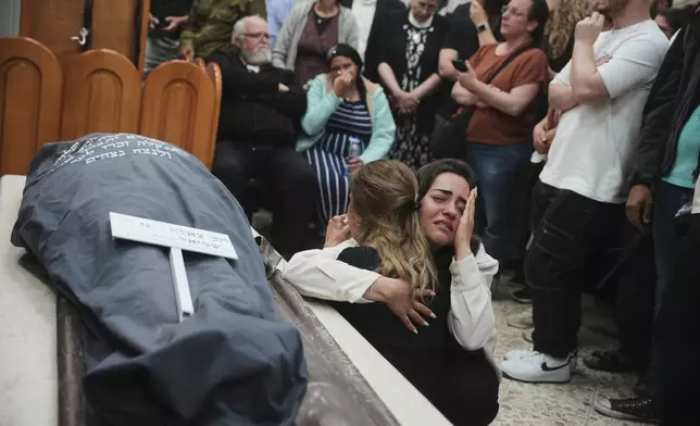 Mourners react next to the body of Tzeela Gez, 37, an Israeli who was on her way to have her baby delivered when she was shot and killed by a Palestinian gunman in the occupied West Bank, during her funeral at Givat Shaul cemetery in Jerusalem on Thursday, May 15, 2025. (AP Photo/Ohad Zwigenberg)