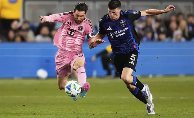 Inter Miami midfielder Lionel Messi, left, and San Jose Earthquakes defender Daniel Munie compete for possession of the ball during the second half of an MLS soccer match Wednesday, May 14, 2025, in San Jose, Calif. (AP Photo/Godofredo A. Vásquez)