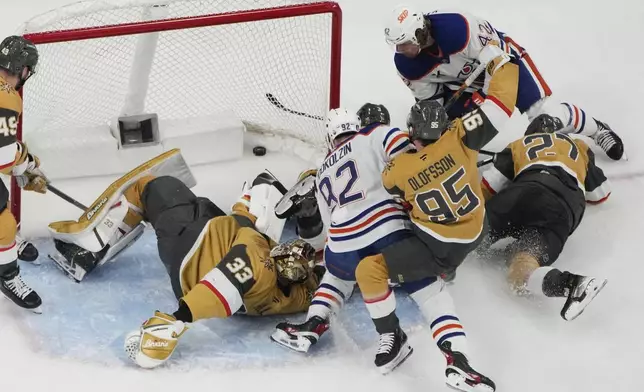 Edmonton Oilers right wing Kasperi Kapanen (42) scores against the Vegas Golden Knights during overtime of Game 5 of a second-round NHL hockey playoff series Wednesday, May 14, 2025, in Las Vegas. (AP Photo/John Locher)