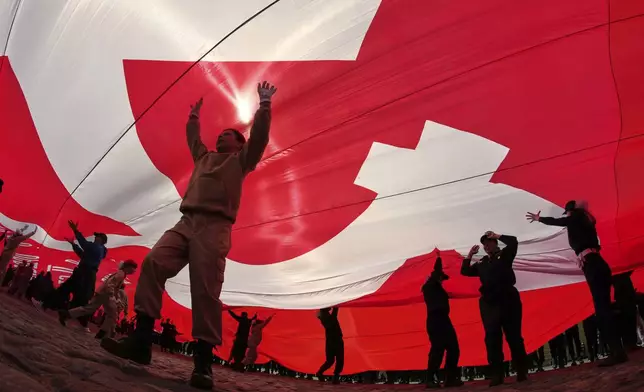 Cadets and young volunteers unfurl a giant replica of the Soviet Flag of Victory, during a continued observance of Victory Day. celebrating 80 years after the victory in World War II, in St. Petersburg, Russia, Thursday, May 15, 2025. (AP Photo/Dmitri Lovetsky)
