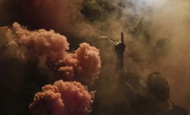 Barcelona fans celebrate in the street after their team won the Spanish La Liga soccer championship in Barcelona, Spain, Thursday, May 15, 2025. (AP Photo/Emilio Morenatti)