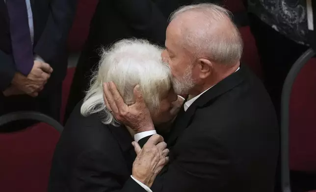 Brazil's President Luiz Inacio Lula Da Silva kisses Lucia Topolansky, widow of former Uruguayan President Jose Mujica, during funeral ceremonies for the late leader at the Legislative Palace in Montevideo, Uruguay, Thursday, May 15, 2025. (AP Photo/Matilde Campodonico)