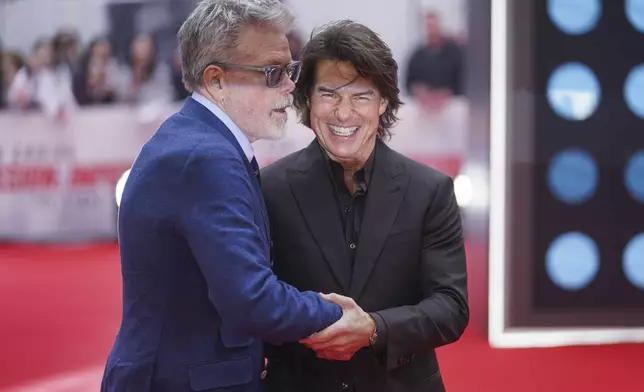 Director Christopher McQuarrie, left, and Tom Cruise pose for photographers upon arrival at the premiere of the film 'Mission: Impossible - The Final Reckoning' on Thursday, May 15, 2025, in London. (Photo by Alberto Pezzali/Invision/AP)