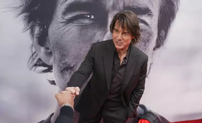 Tom Cruise poses for photographers upon arrival at the premiere of the film 'Mission: Impossible - The Final Reckoning' on Thursday, May 15, 2025, in London. (Photo by Alberto Pezzali/Invision/AP)