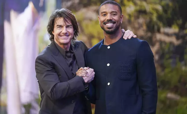 Tom Cruise, left, and Michael B. Jordan pose for photographers upon arrival at the premiere of the film 'Mission: Impossible - The Final Reckoning' on Thursday, May 15, 2025, in London. (Photo by Alberto Pezzali/Invision/AP)