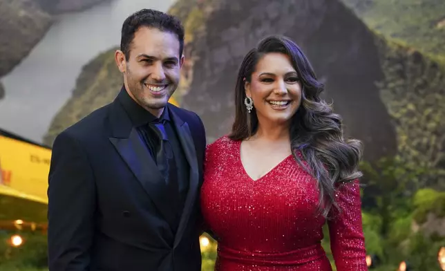 Jeremy Parisi, left, and Kelly Brook pose for photographers upon arrival at the premiere of the film 'Mission: Impossible - The Final Reckoning' on Thursday, May 15, 2025, in London. (Photo by Alberto Pezzali/Invision/AP)