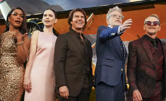 Angela Bassett, from left, Hayley Atwell, Tom Cruise, director Christopher McQuarrie, and Simon Pegg pose for photographers upon arrival at the premiere of the film 'Mission: Impossible - The Final Reckoning' on Thursday, May 15, 2025, in London. (Photo by Alberto Pezzali/Invision/AP)