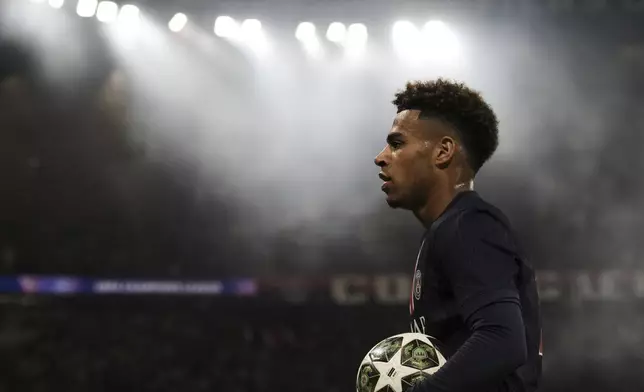 PSG's Desire Doue holds the ball during the Champions League semifinal, second leg soccer match between Paris Saint-Germain and Arsenal at the Parc des Princes in Paris, Wednesday, May 7, 2025. (AP Photo/Aurelien Morissard)