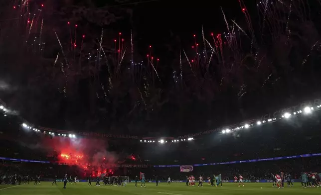 PSG fans celebrate after the Champions League semifinal, second leg soccer match between Paris Saint-Germain and Arsenal at the Parc des Princes in Paris, Wednesday, May 7, 2025. (AP Photo/Aurelien Morissard)