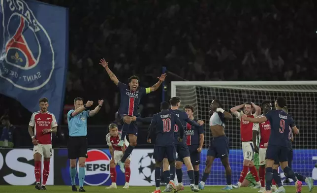 PSG players celebrate after the Champions League semifinal, second leg soccer match between Paris Saint-Germain and Arsenal at the Parc des Princes in Paris, Wednesday, May 7, 2025. (AP Photo/Thibault Camus)