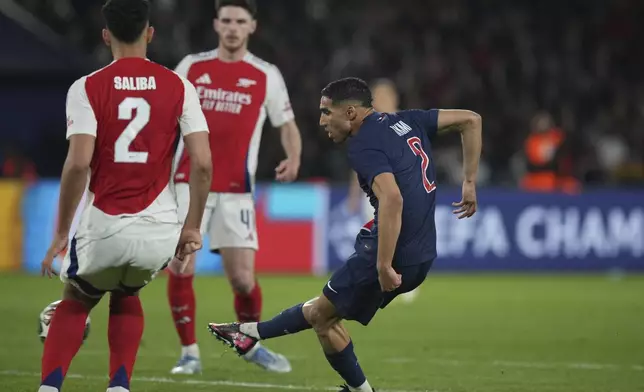 PSG's Achraf Hakimi shoots to score his sides second goal during the Champions League semifinal, second leg soccer match between Paris Saint-Germain and Arsenal at the Parc des Princes in Paris, Wednesday, May 7, 2025. (AP Photo/Thibault Camus)