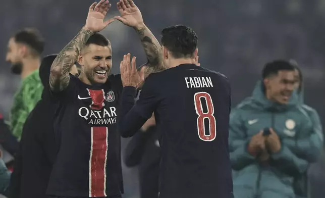 PSG's Lucas Hernandez, left, and PSG's Fabian Ruiz celebrate after the Champions League semifinal, second leg soccer match between Paris Saint-Germain and Arsenal at the Parc des Princes in Paris, Wednesday, May 7, 2025. (AP Photo/Aurelien Morissard)