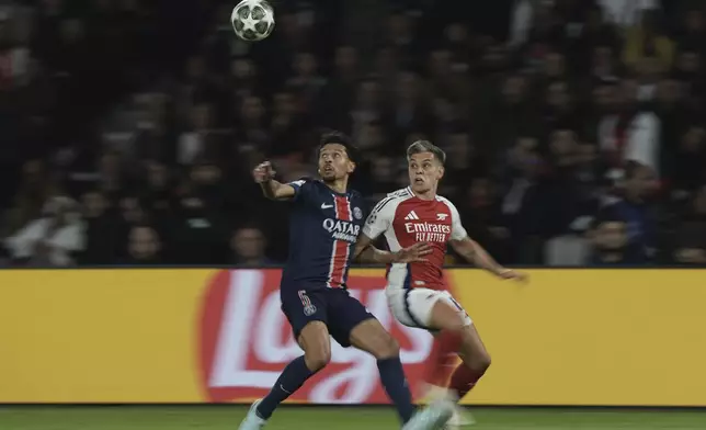 PSG's Marquinhos, left, and Arsenal's Leandro Trossard challenge for the ball during the Champions League semifinal, second leg soccer match between Paris Saint-Germain and Arsenal at the Parc des Princes in Paris, Wednesday, May 7, 2025. (AP Photo/Aurelien Morissard)
