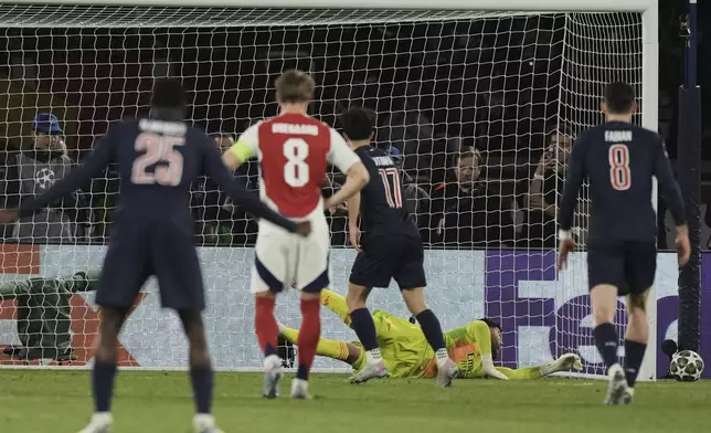 Arsenal's goalkeeper David Raya saves a penalty by PSG's Vitinha during the Champions League semifinal, second leg soccer match between Paris Saint-Germain and Arsenal at the Parc des Princes in Paris, Wednesday, May 7, 2025. (AP Photo/Aurelien Morissard)