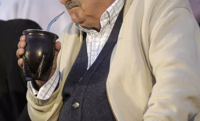 FILE - Presidential candidate Jose Mujica drinks mate during a closing campaign rally in Pando, Uruguay, Oct. 22, 2009. (AP Photo/Matilde Campodonico, File)