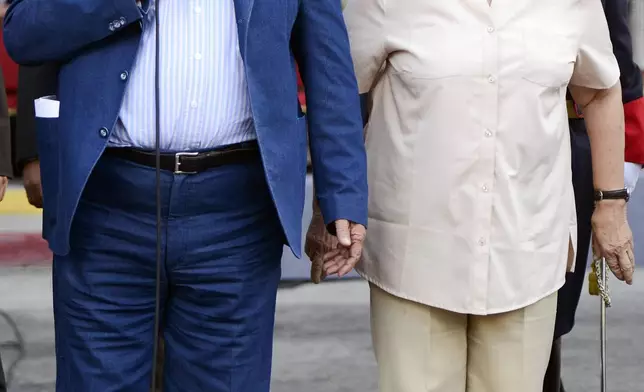 FILE - Uruguay's President Jose Mujica, left, and his wife Lucia Topolansky attend a flag ceremony in Montevideo, Uruguay, Feb. 27, 2015. (AP Photo/Matilde Campodonico, File)