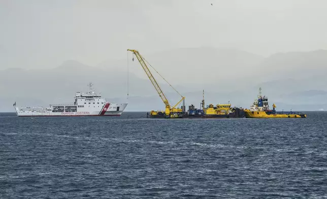 Italian Coast Guard's Luigi Dattilo patrol boat, left, assists the multi-purpose floating work barge Hebo Lift 2 monitoring the stretch of sea off Porticello, near Palermo, Sicily, Italy, Sunday, May 4, 2025, where the British superyacht Bayesian sunk on August 19, 2024 as the operations for its recovery start. (AP Photo/Salvatore Cavalli)