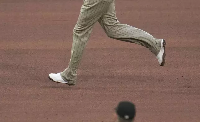 San Diego Padres' Manny Machado, top, rounds the bases after hitting a solo home run off Pittsburgh Pirates pitcher Bailey Falter (6) during the seventh inning of a baseball game in Pittsburgh, Saturday, May 3, 2025. (AP Photo/Gene J. Puskar)