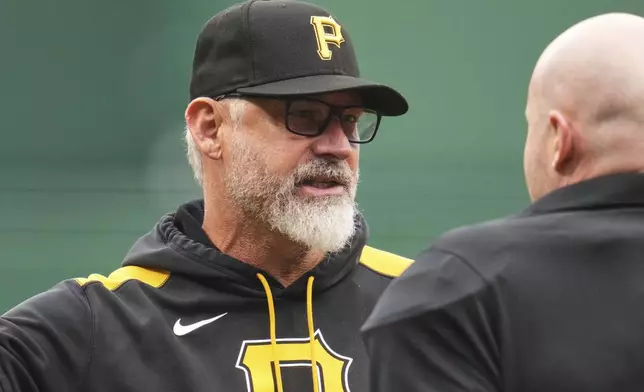 Pittsburgh Pirates manager Derek Shelton, left, talks with umpire Mike Estabrook between innings of a baseball game against the San Diego Padres in Pittsburgh, Saturday, May 3, 2025. (AP Photo/Gene J. Puskar)